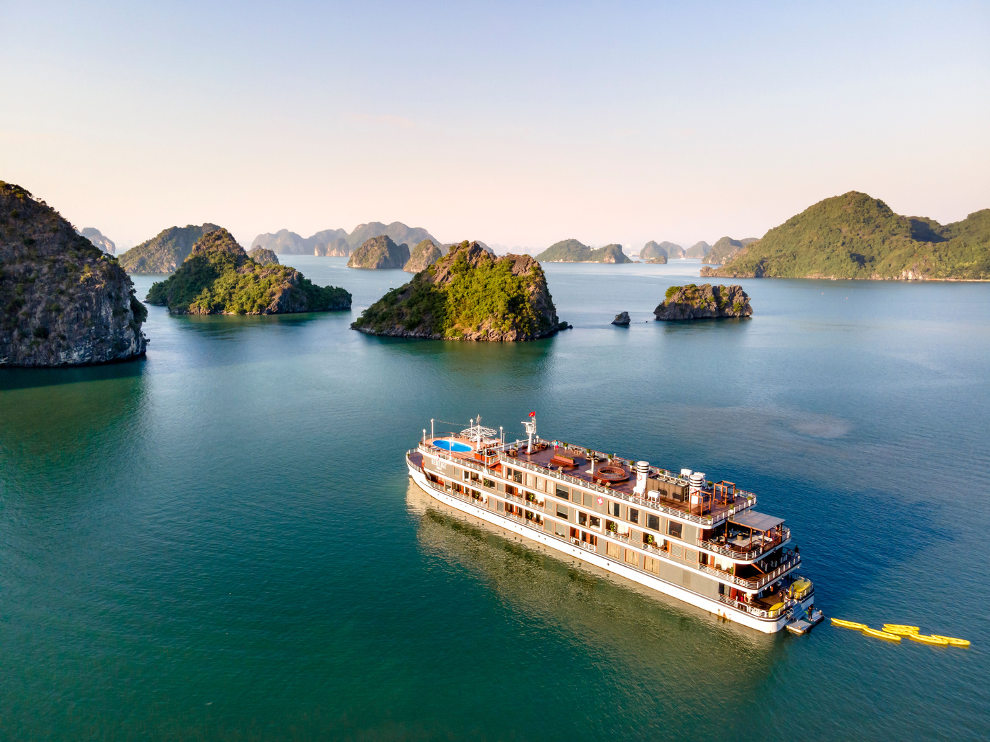 Cruise ship sailing among limestone karst islands