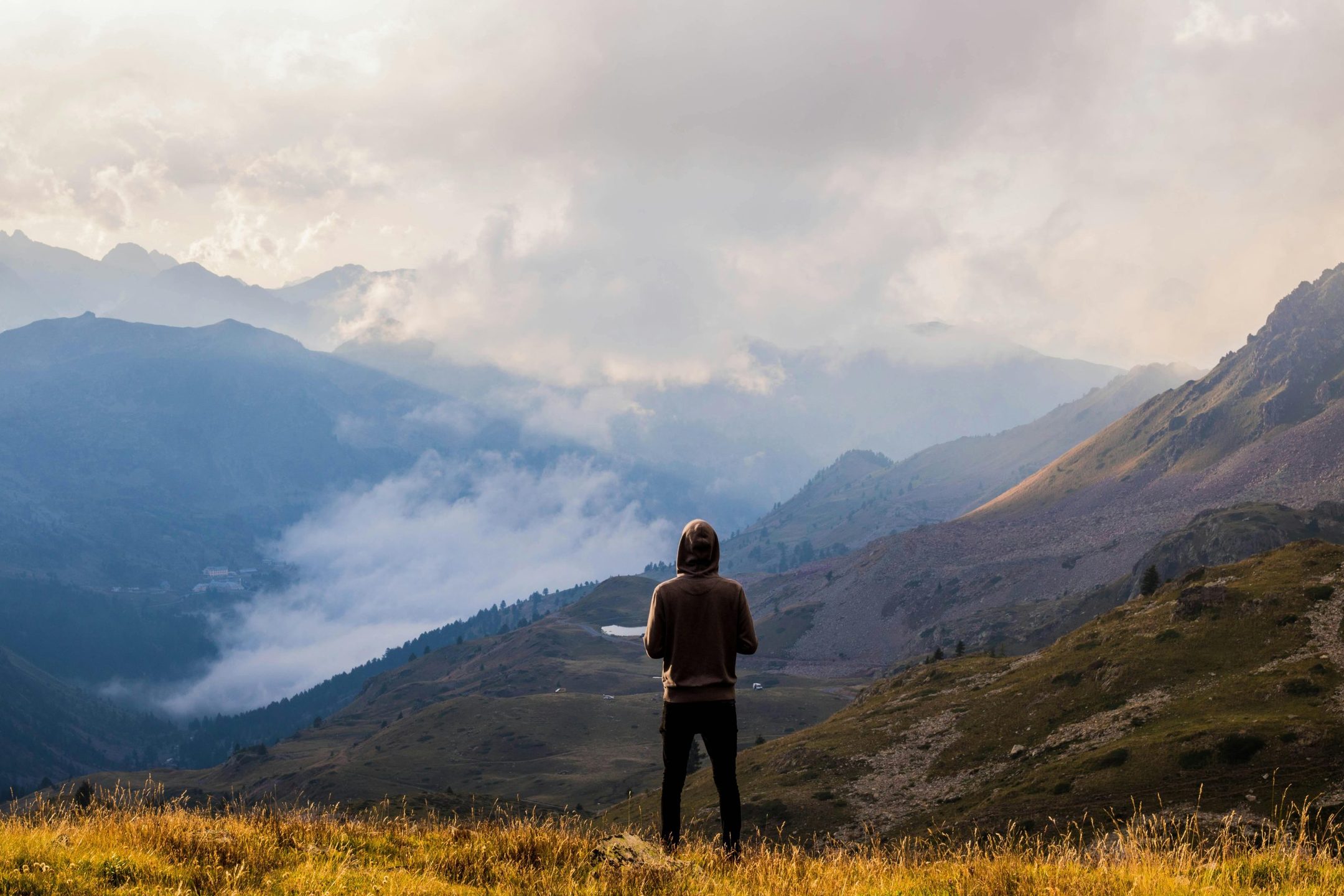 Person overlooking a misty mountain valley during a sabbatical rest trip