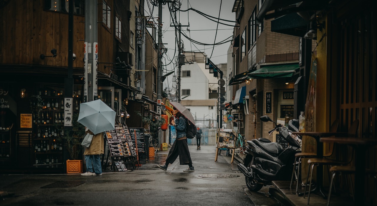 Narrow street market with scooters after rain