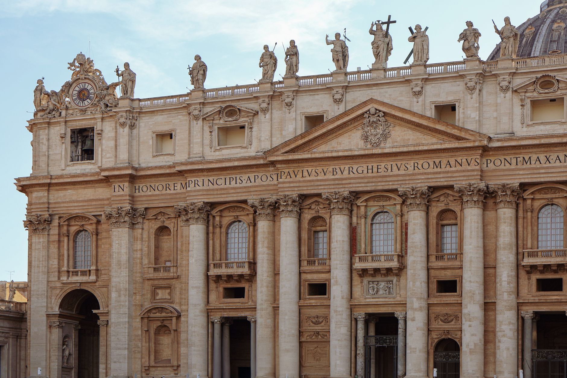 The facade of St Peter's Basilica with statues ranged along its roofline