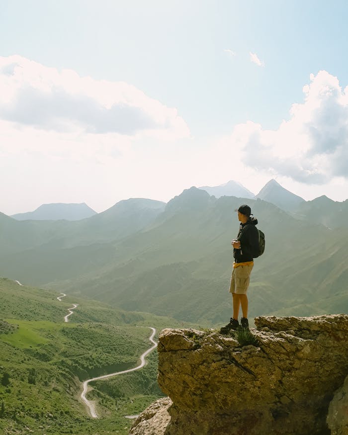gallery-1 A lone hiker overlooks a vast mountain landscape, a moment of reflection that ministry travel can provide pastors.