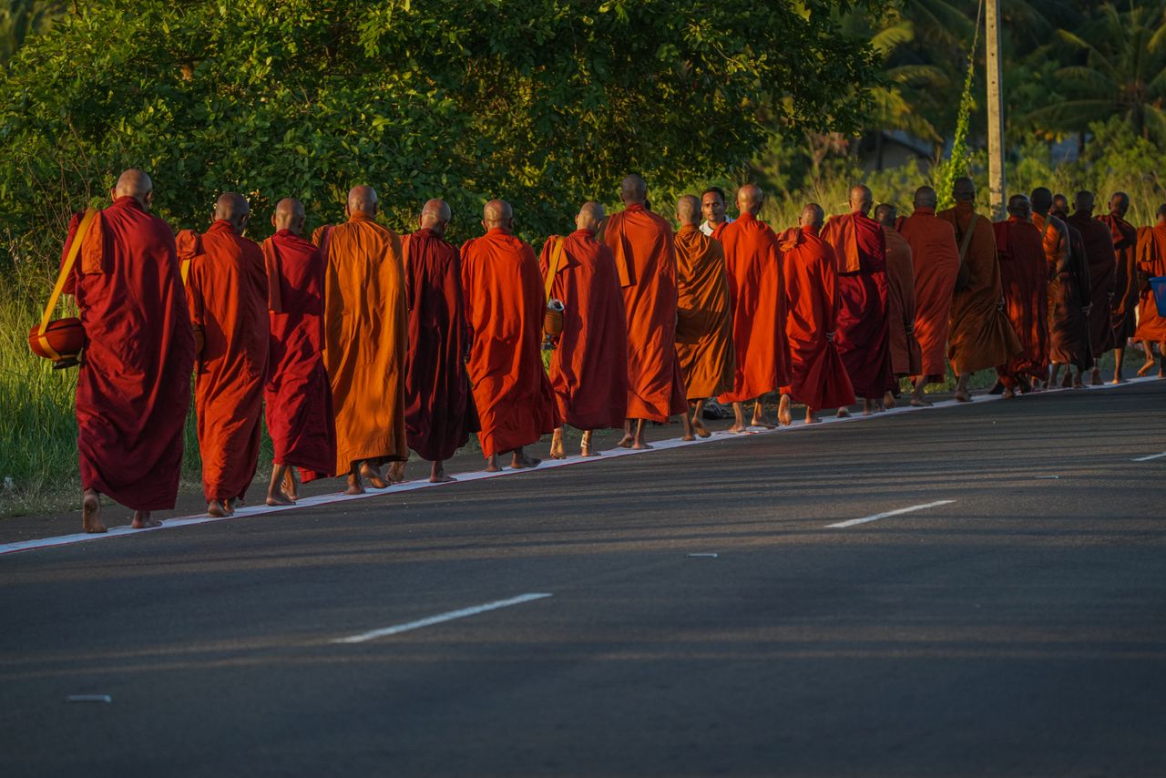 services-02 A group of monks walking a sunlit road in Sri Lanka, the kind of cultural encounter ministry travel makes possible.