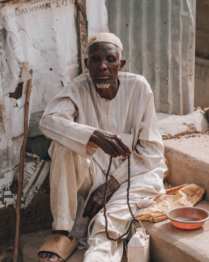 gallery-4 An elderly man sits with prayer beads, reflecting the kind of cultural connection ministry travel can deepen.