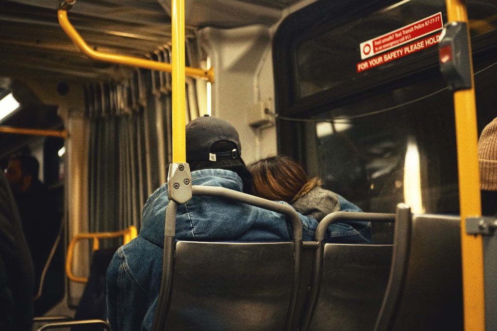 A couple sitting together on a Vancouver bus, showcasing city transportation.